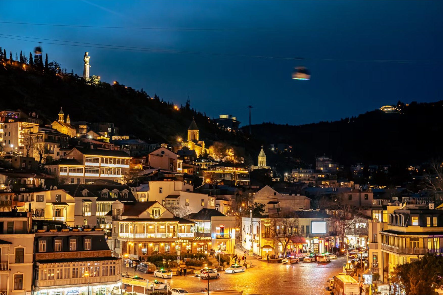 Old Tbilisi at night, with Kartlis Deda on the hill above