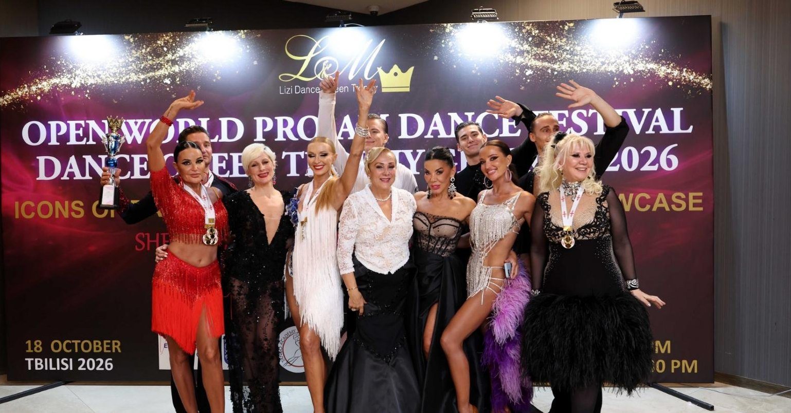Pro-Am winners with their trophy in front of the festival backdrop